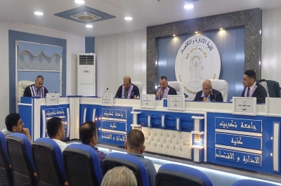 A prof at the University of Kirkuk participates in the discussion of a master's thesis at the University of Tikrit