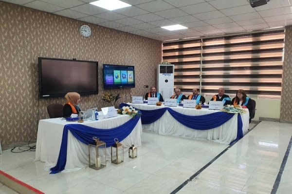 A teacher at the University of Kirkuk participates in a committee to discuss a master&#039;s thesis at the University of Mosul