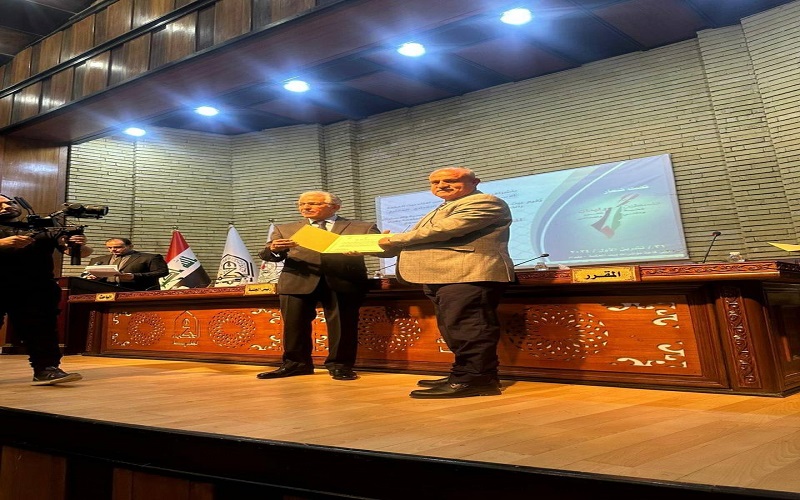A lecturer from the College of Law and Political Science participates in a scientific conference at the College of Political Science at the University of Baghdad